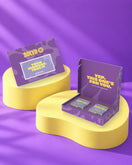 Giftbox 'This is your moment. Take it' op gele sokkels in paarse studio